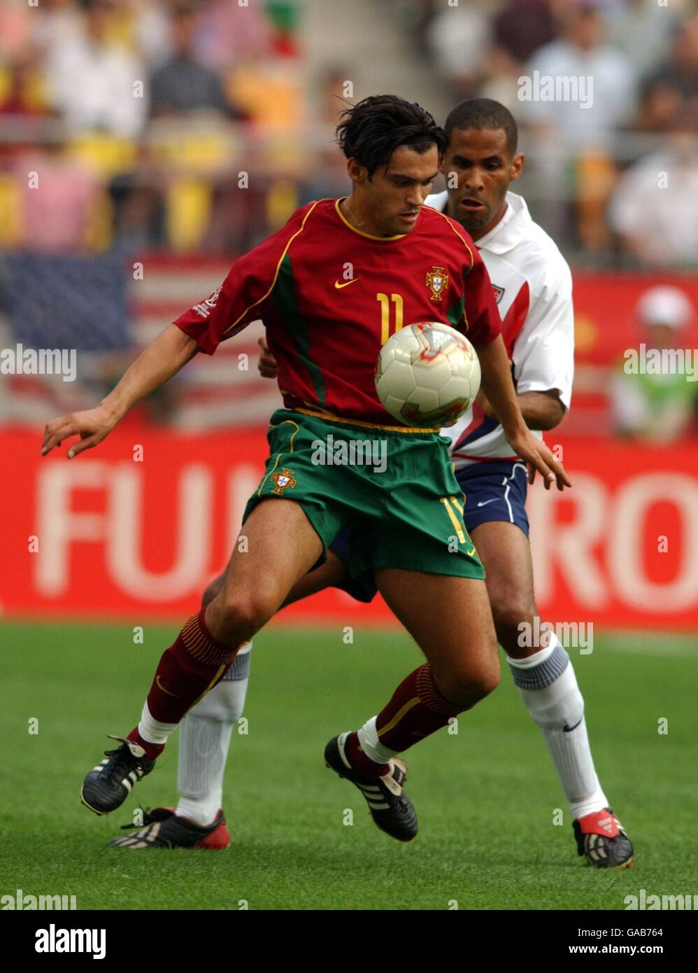 Soccer - FIFA World Cup 2002 - Group D - USA v Portugal. USA's Anthony  Sanneh and Portugal's Sergio Conceicao Stock Photo - Alamy