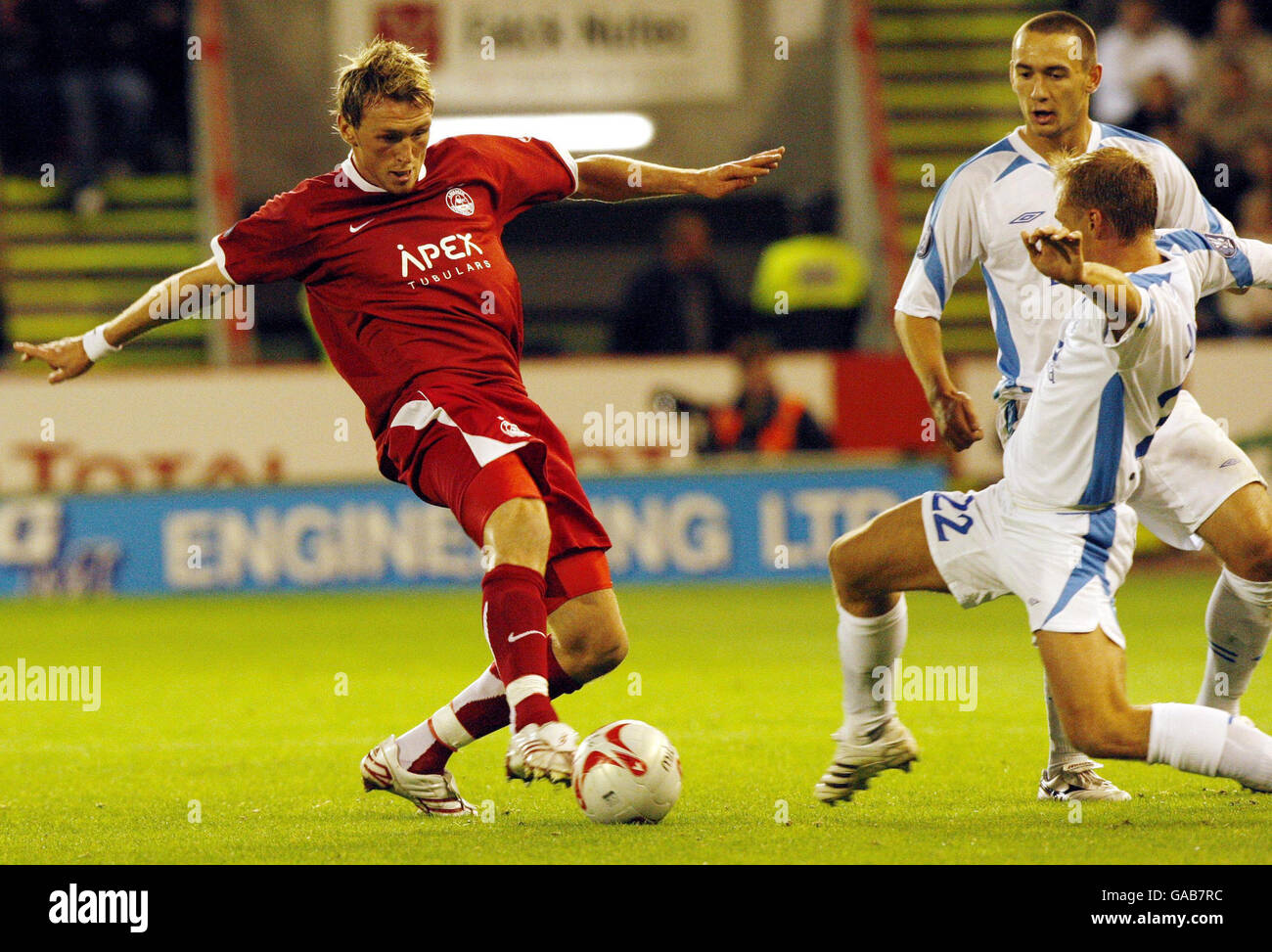 Aberdeen's Lee Miller and Dnipro's Denys Andriyenko (right) in action during the UEFA Cup First Round First Leg match at Pittodrie Stadium, Aberdeen. Stock Photo