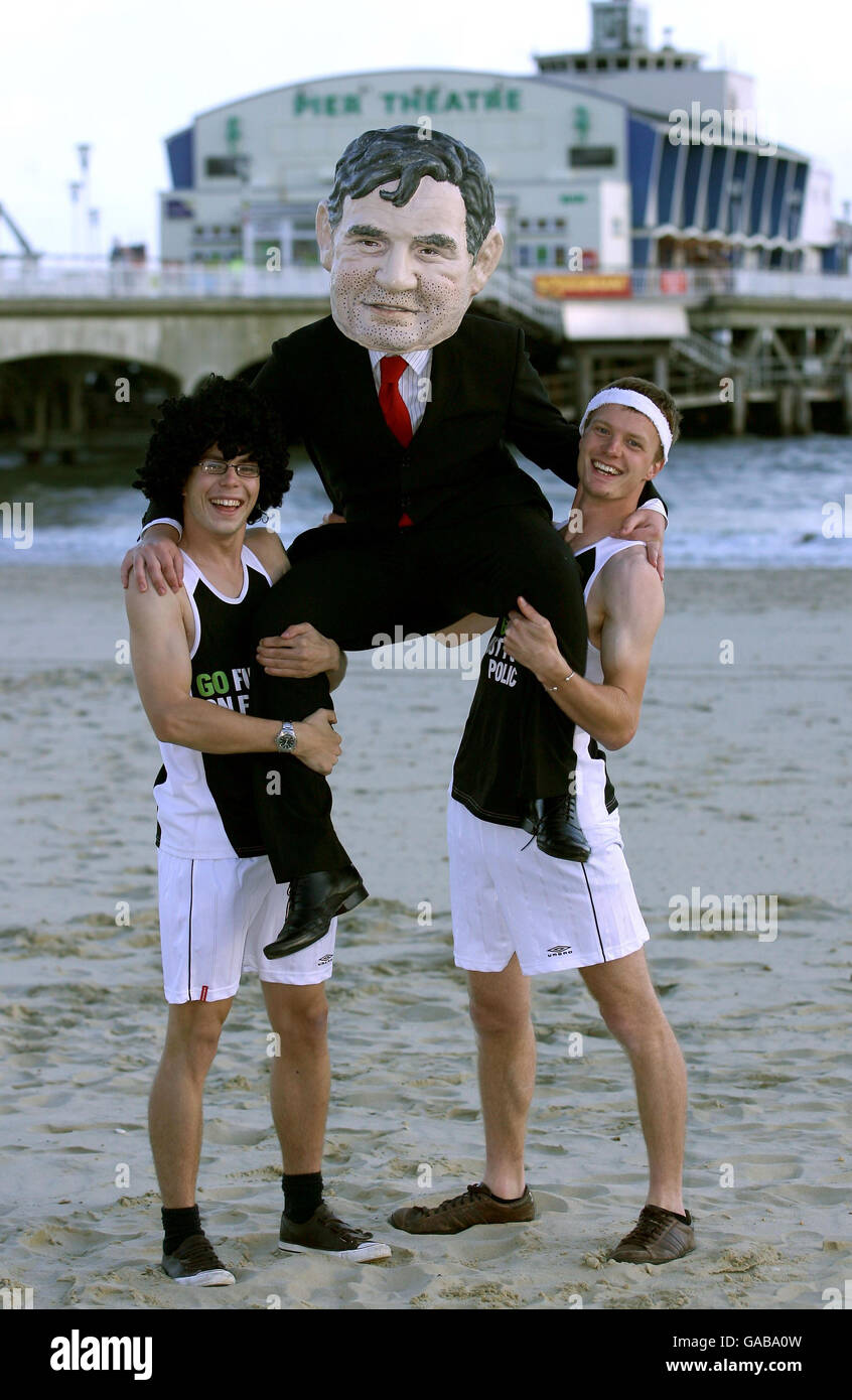 Oxfam campaigners wearing running gear and dressed as Prime Minister Gordon Brown on Bournemouth beach, Dorset. Stock Photo
