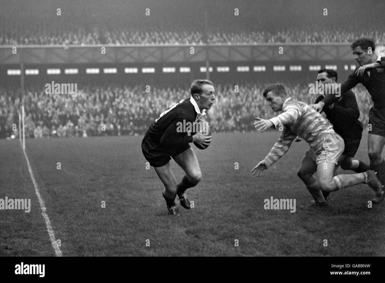 Rugby Union - Oxford University v Cambridge University - Twickenham. Peter Dawkins, the American at Oxford, getting away with the ball as he is about to be tackled by D.F.B Wrench of Cambridge. Stock Photo