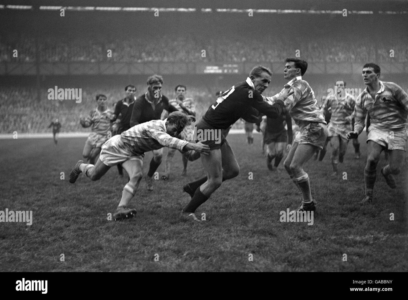 Rugby Union - Oxford University v Cambridge University - Twickenham. Peter Dawkins, the American at Oxford, is tackled by J.C Brash (left) and W.M Bussey of Cambridge (right). Stock Photo