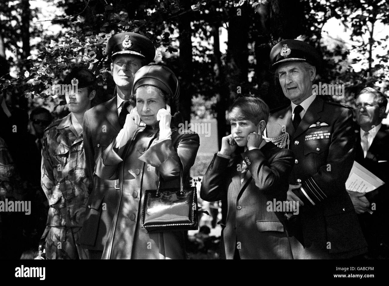 Queen Elizabeth II and Prince Edward shield their ears at RAF Finningley, near Doncaster, during the Silver Jubilee Review of the Royal Air Force. Stock Photo