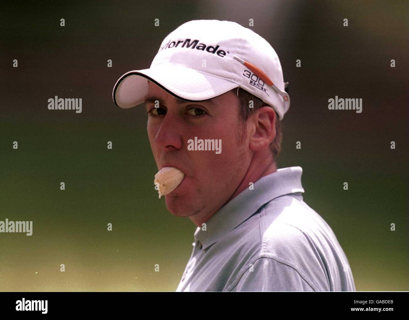 Ian Poulter sucks on a banana during the 2nd round which moved him to nine under par Stock Photo