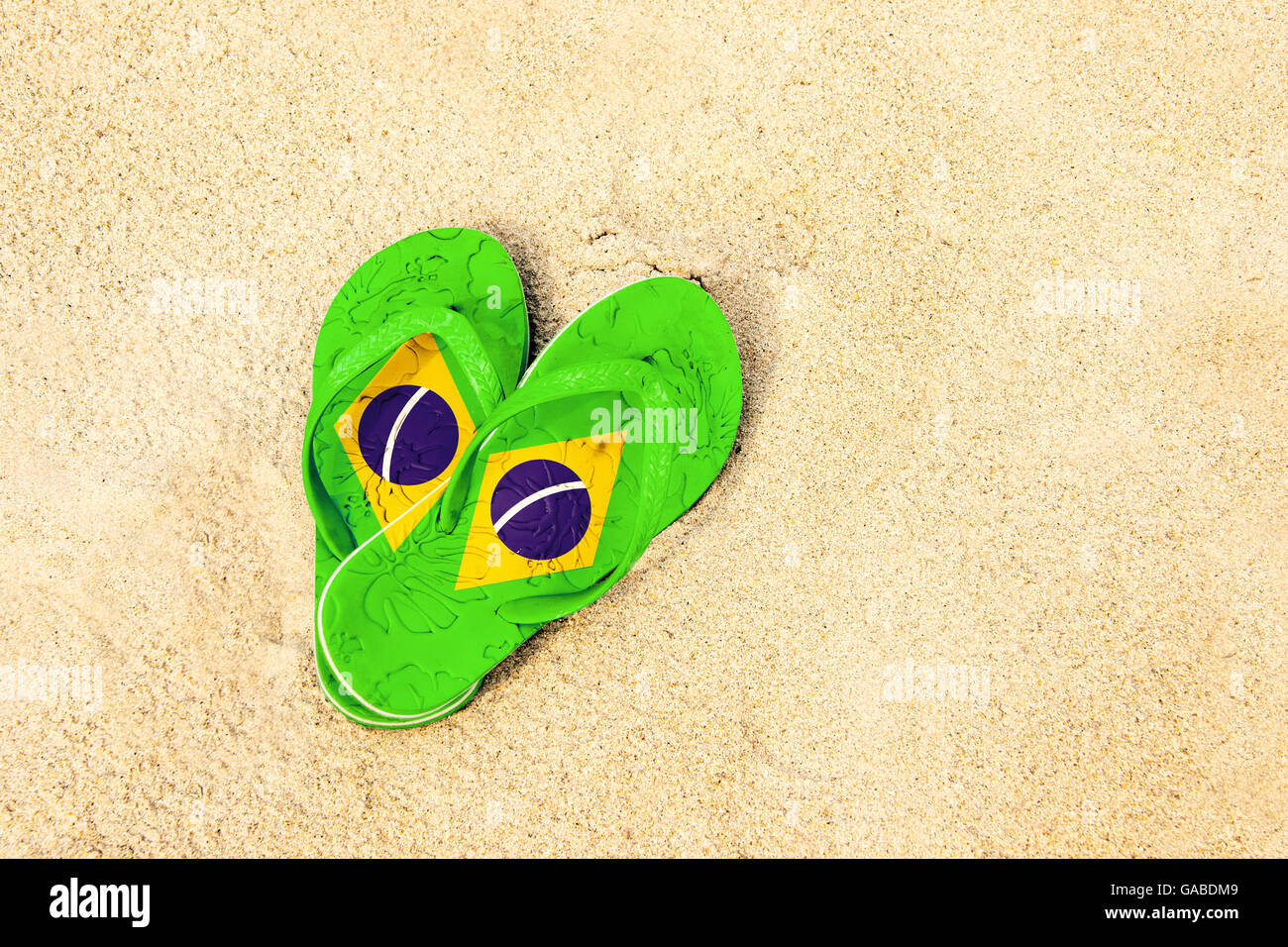Brazilian colored flip flops on the beach Stock Photo