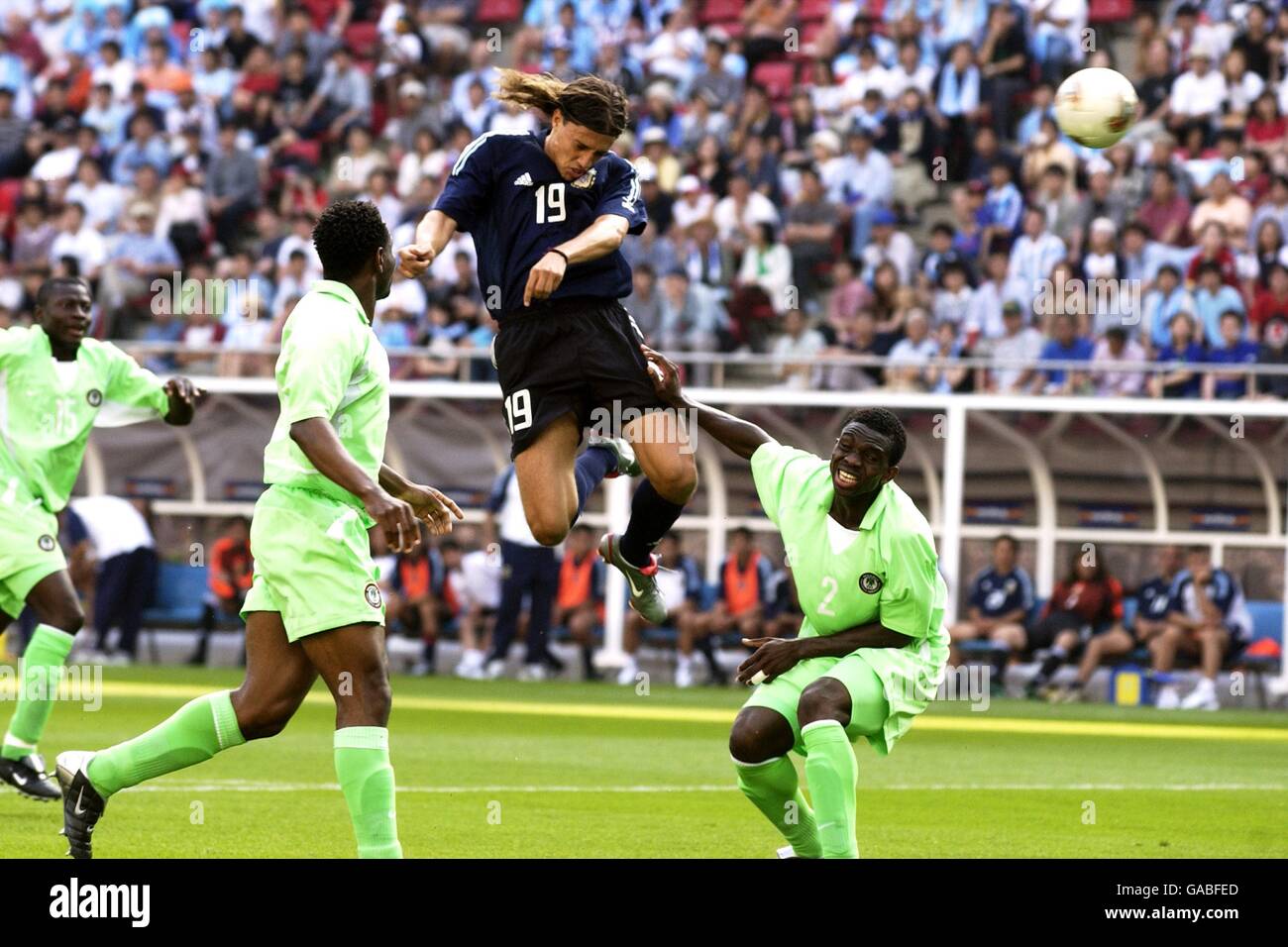 Argentina's Hernan Crespo gets in a header on goal watched by Nigeria defenders Isaac Okoronkwo (l) and Joseph Yobo (r) Stock Photo