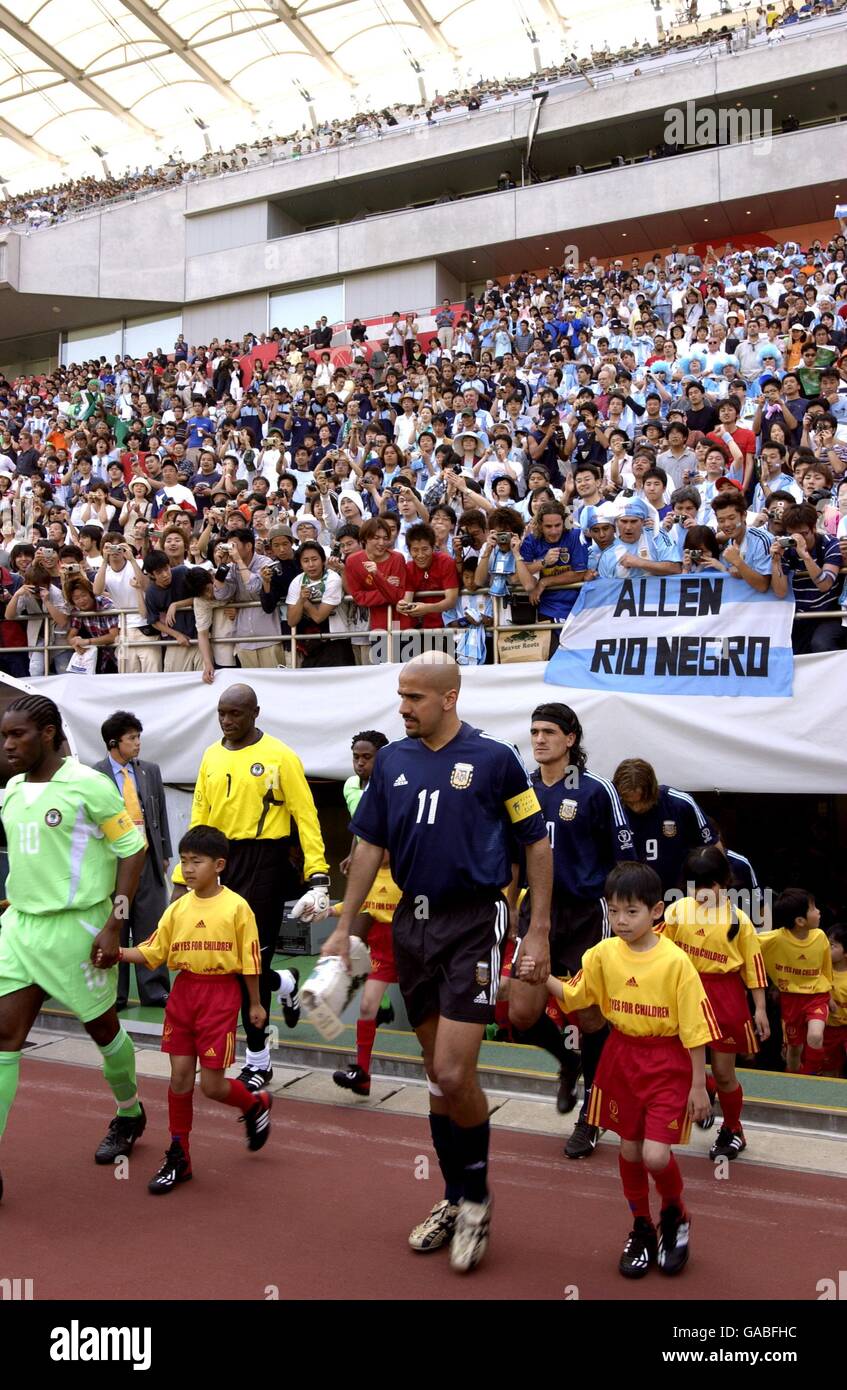 Soccer - FIFA World Cup 2002 - Group F - Argentina v Nigeria. Nigeria's captain Jay Jay Okocha (l) and Argentina's captain Juan Veron lead their teams out onto the pitch Stock Photo