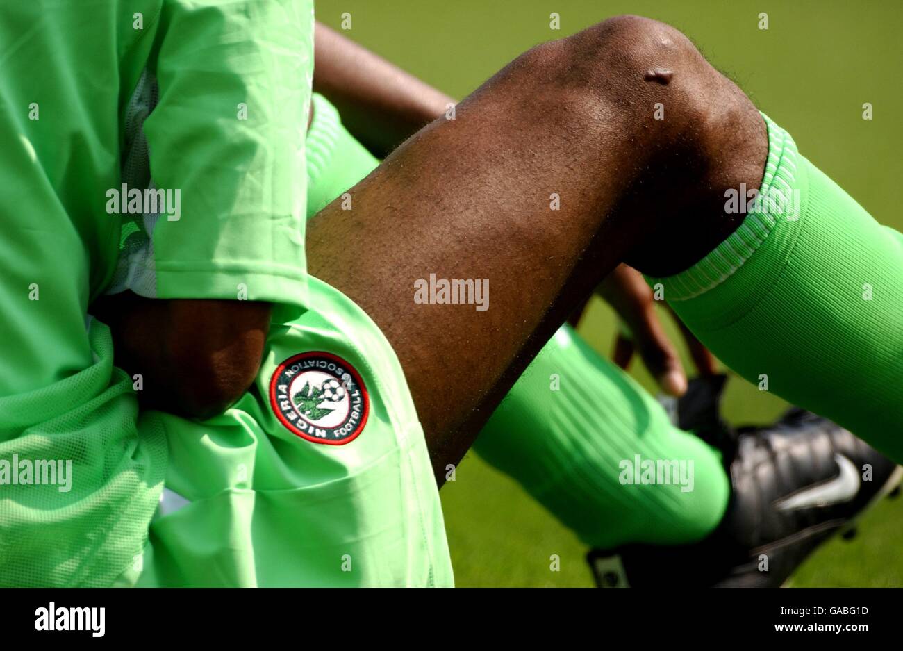 Nigeria's Nwankwo Kanu sits down to recover from an Argentina tackle Stock Photo
