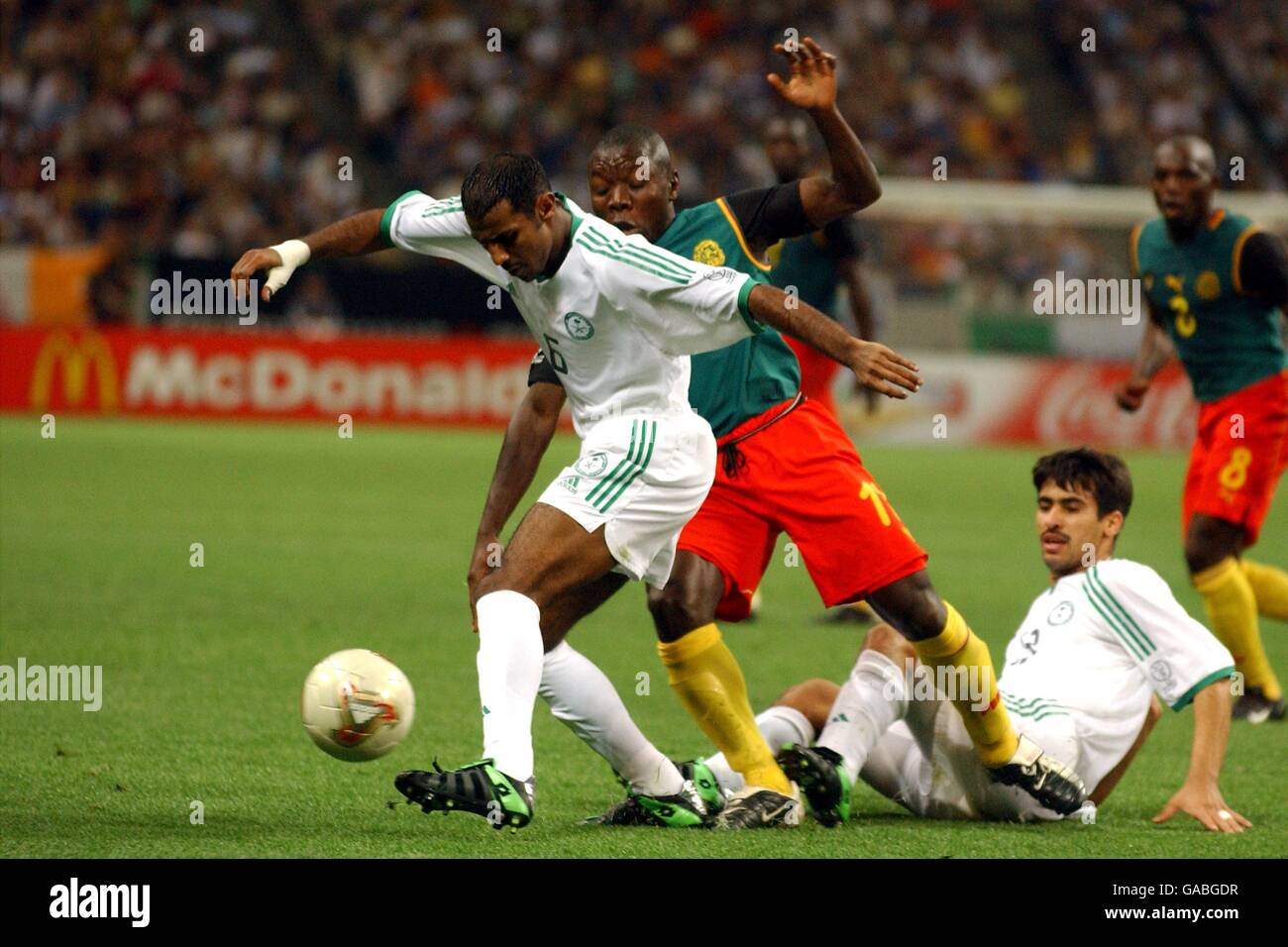 Soccer - FIFA World Cup 2002 - Group E - Cameroon v Saudi Arabia. Saudi Arabia's Fouzi Al Shehri (l) clears the danger from Cameroon's Pius Ndiefi Stock Photo