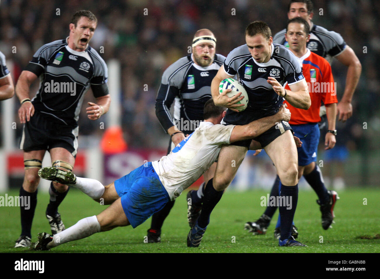 Scotland's Andrew Henderson is tackled by Italy's Alessandro Troncon during the IRB Rugby World Cup Pool C match at Stade Geoffroy-Guichard, St Etienne, France. Stock Photo
