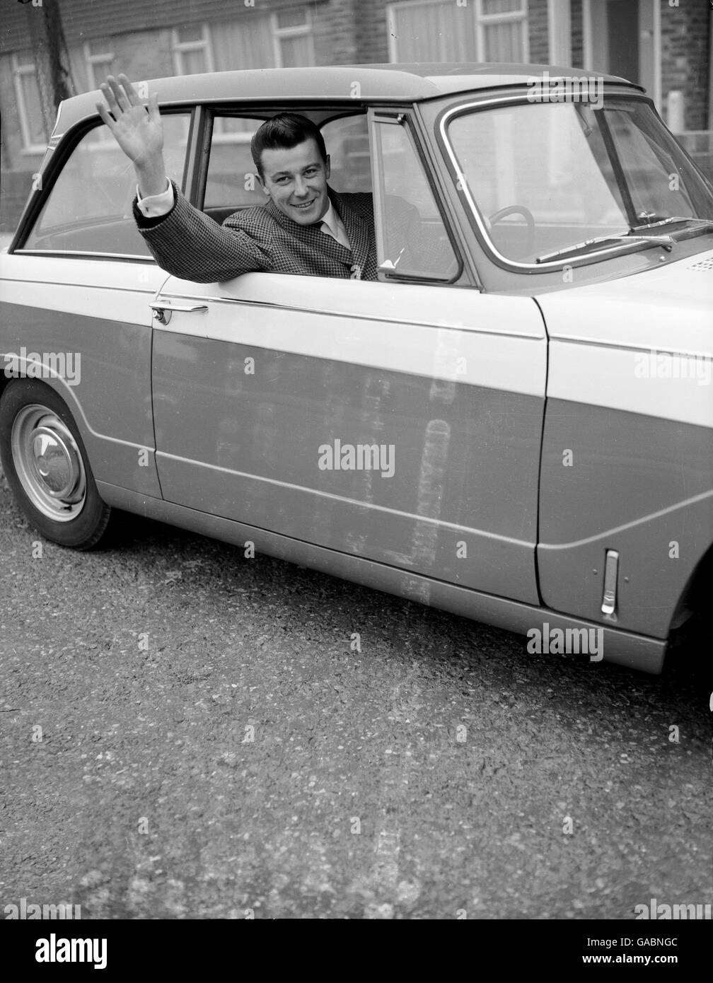 Crystal Palace's Johnny Byrne waves to his wife as he sets off for training, having been selected to play for England for the first time Stock Photo