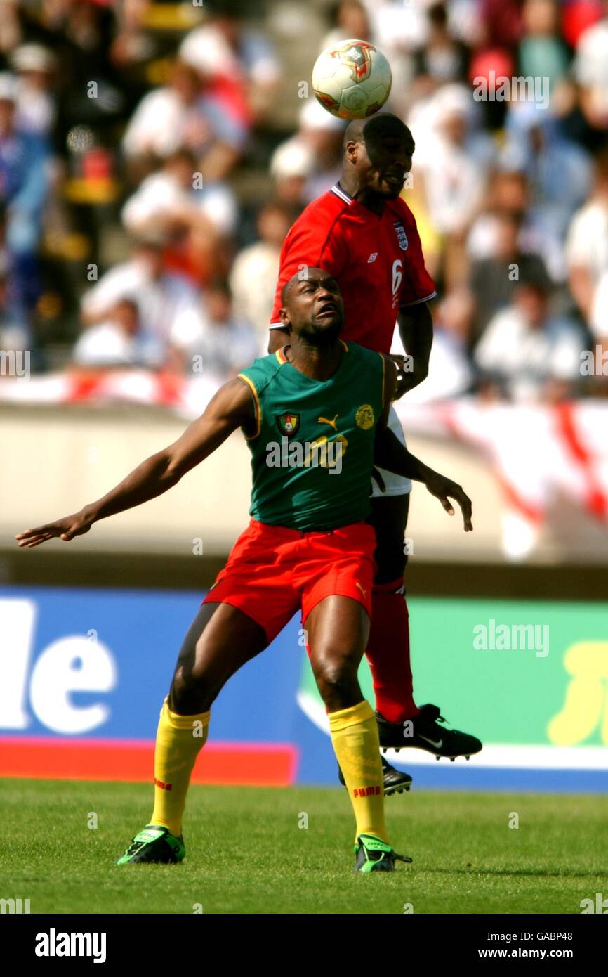 England's Sol Campbell (back) wins an aerial dual with Cameroon's Patrick Mboma Stock Photo