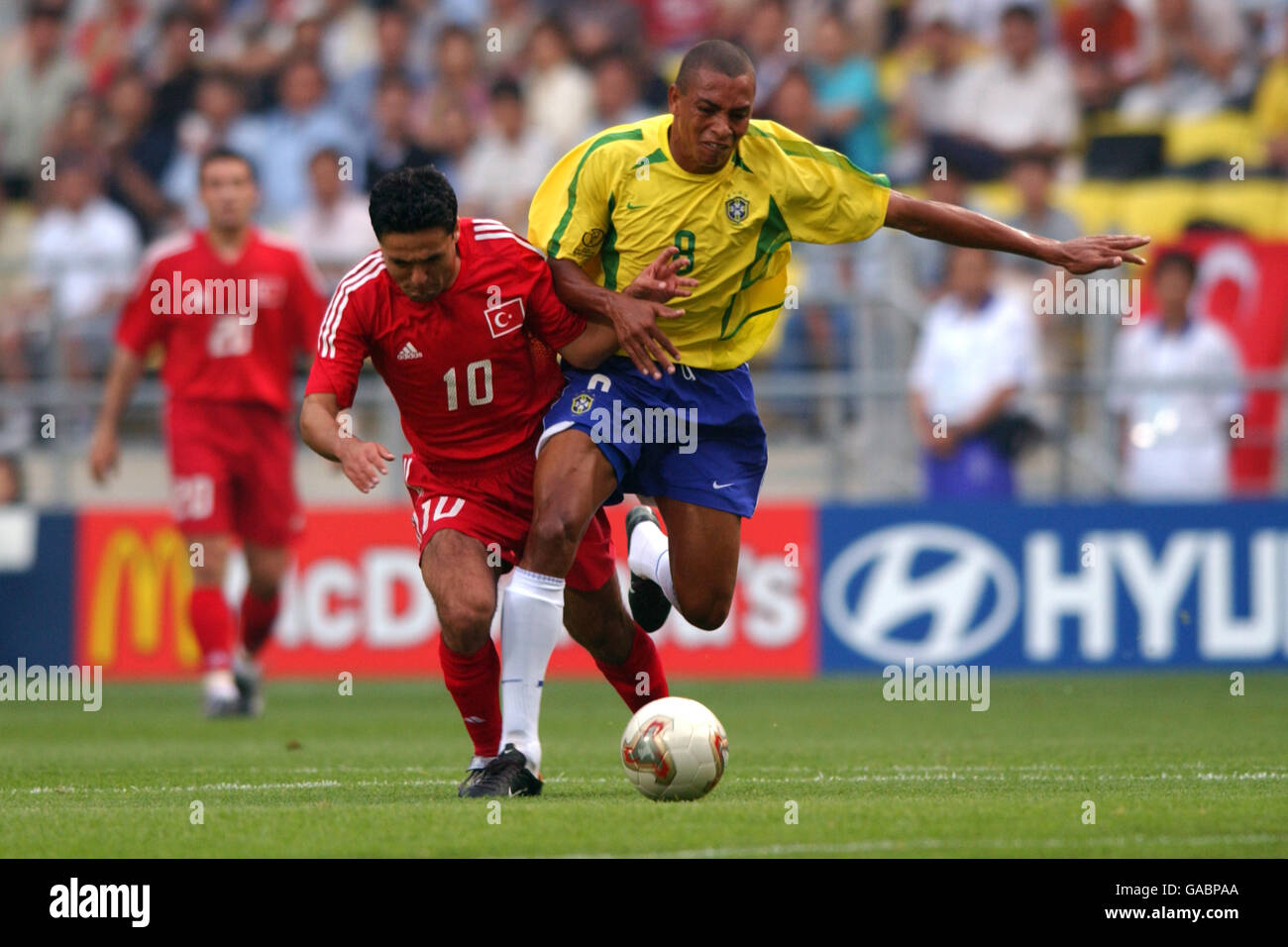 Soccer - FIFA World Cup 2002 - Group C - Brazil v Turkey. Brazil's Gilberto Silva battles against Turkey's Yildiray Basturk Stock Photo