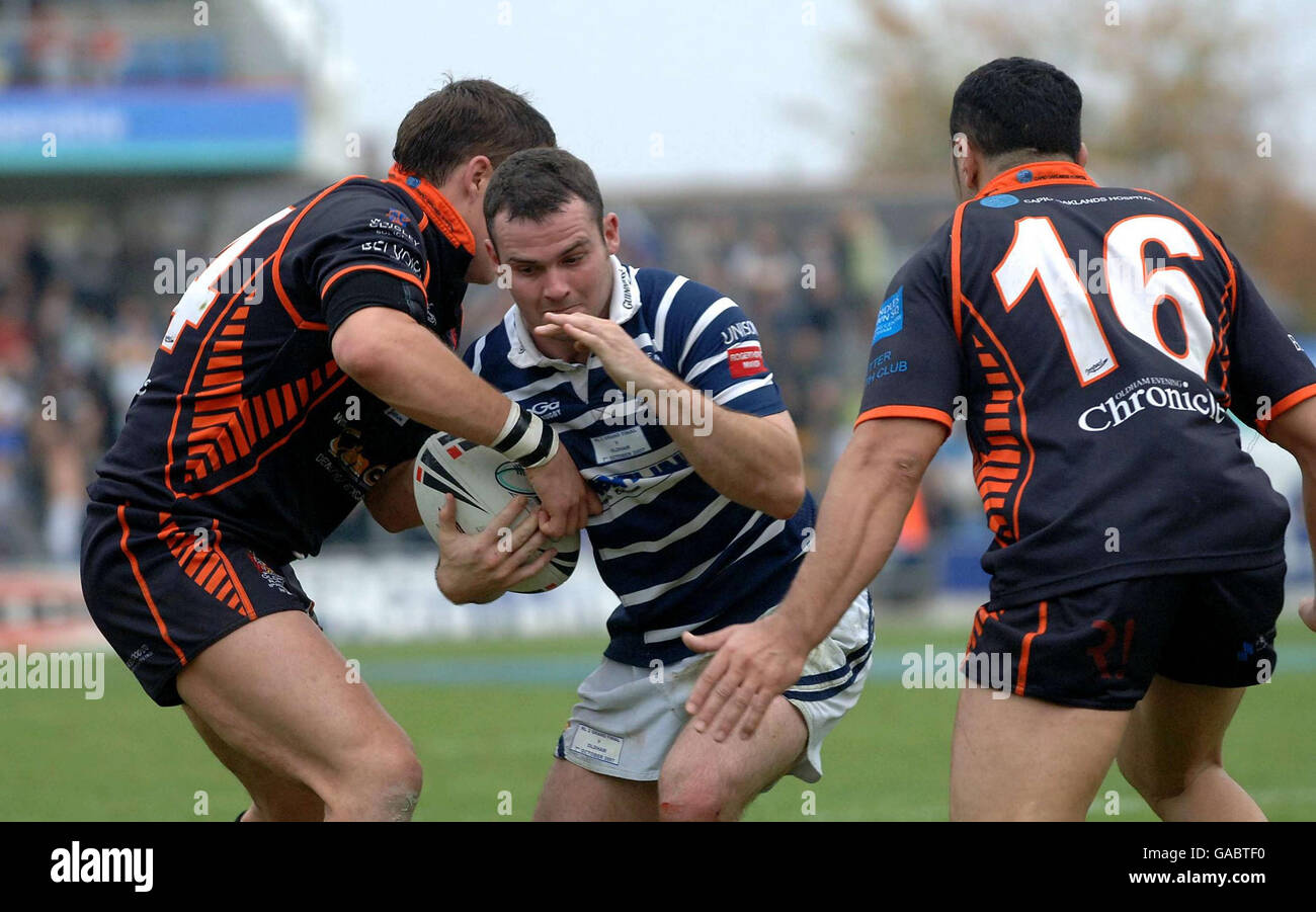 Featherstone Rovers' Gareth Handford (centre) is tackled by Oldham's Alex Wilkinson (left) and Said Tamghart during the Co-operative National League Two Final at Headingley Carnegie Stadium, Leeds. Stock Photo