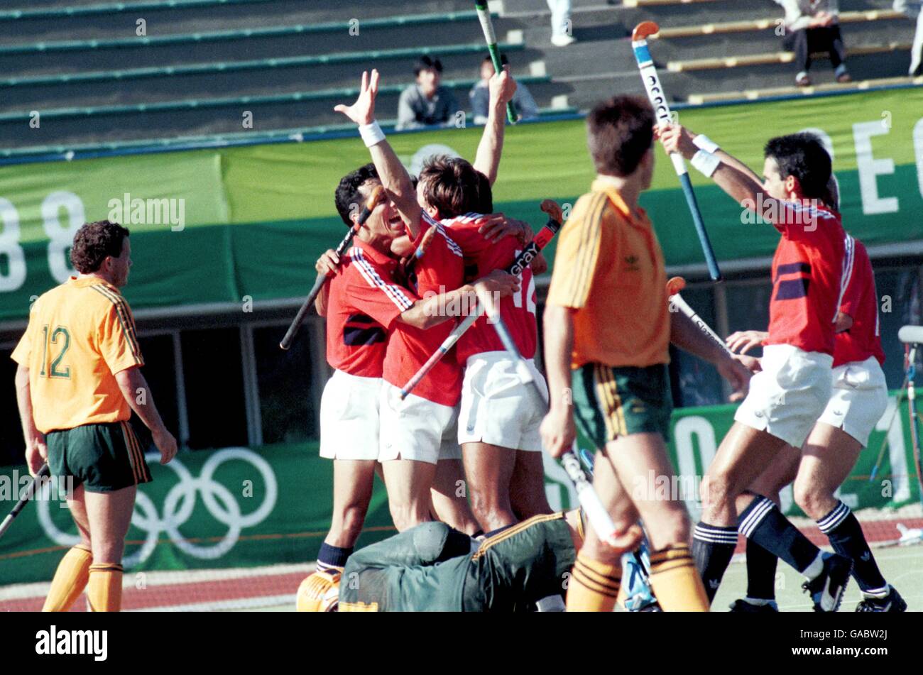 Great Britain's Sean Kerly (second l) is mobbed by teammates after scoring the winning goal late in the match Stock Photo