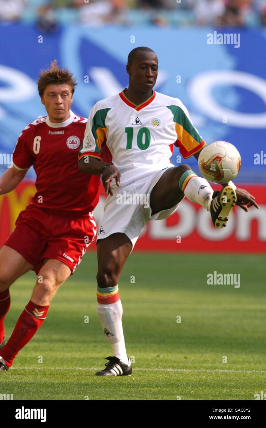 Soccer -FIFA World Cup 2002 - Group A - Denmark v Senegal. Senegal's Khalilou Fadiga (r) is closed down by Thomas Helveg (l) Stock Photo