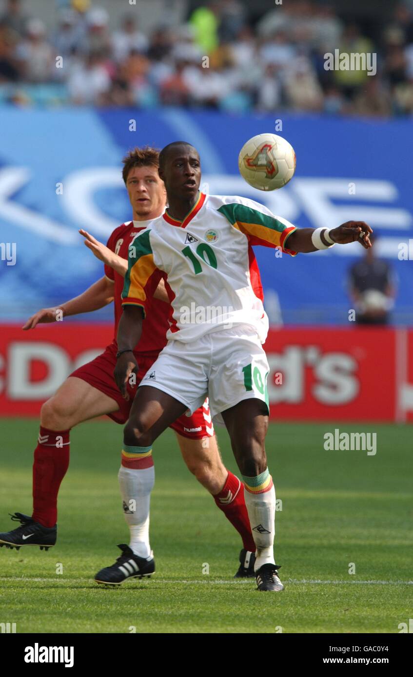 Soccer -FIFA World Cup 2002 - Group A - Denmark v Senegal. Senegal's Khalilou Fadiga (r) is closed down by Thomas Helveg (l) Stock Photo