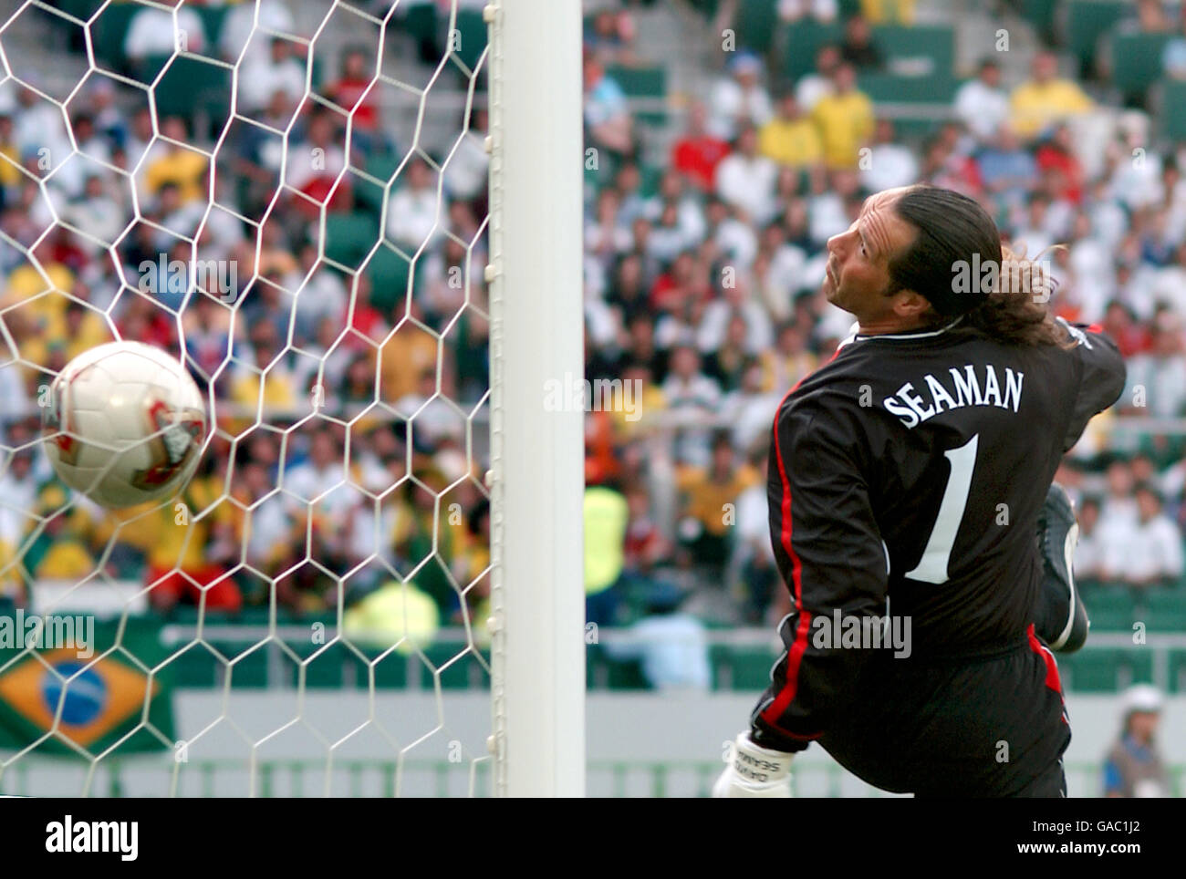 Soccer - FIFA World Cup 2002 - Quarter Final - England v Brazil. England's David Seaman can only watch as he is beaten by Brazil's Ronaldinho for their winning goal from a free-kick. Stock Photo