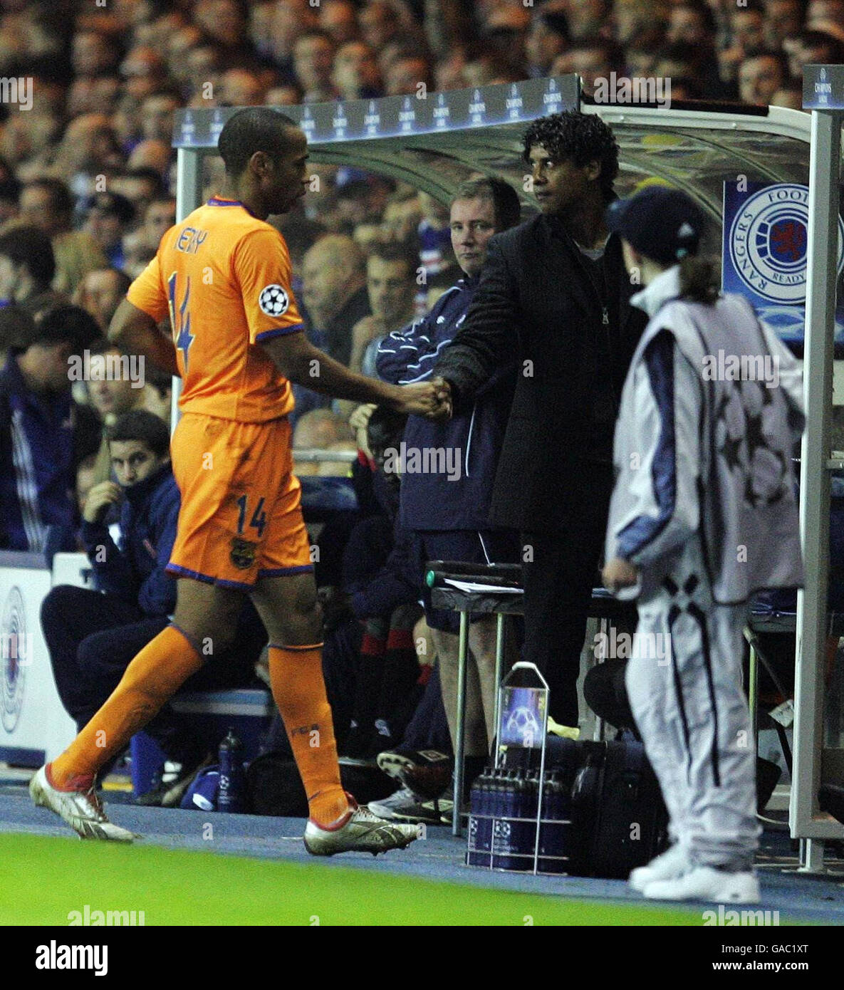 Barcelona's Thierry Henry shakes hands with manager Frank Rijkaard as he is taken off during the UEFA Champions League Group E match at Ibrox Stadium, Glasgow. Stock Photo