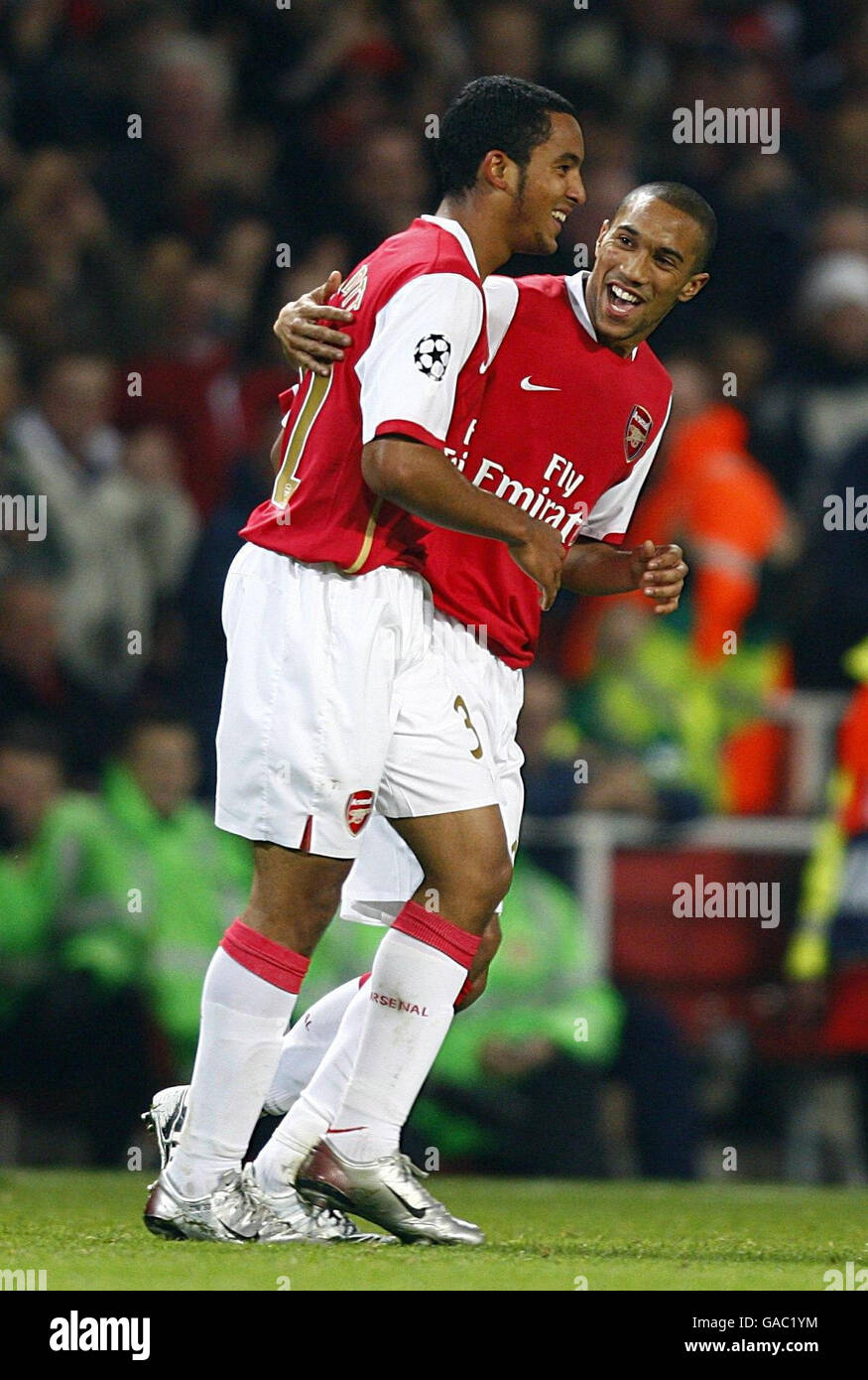 Arsenal's Theo Walcott (left) celebrates scoring their third goal with