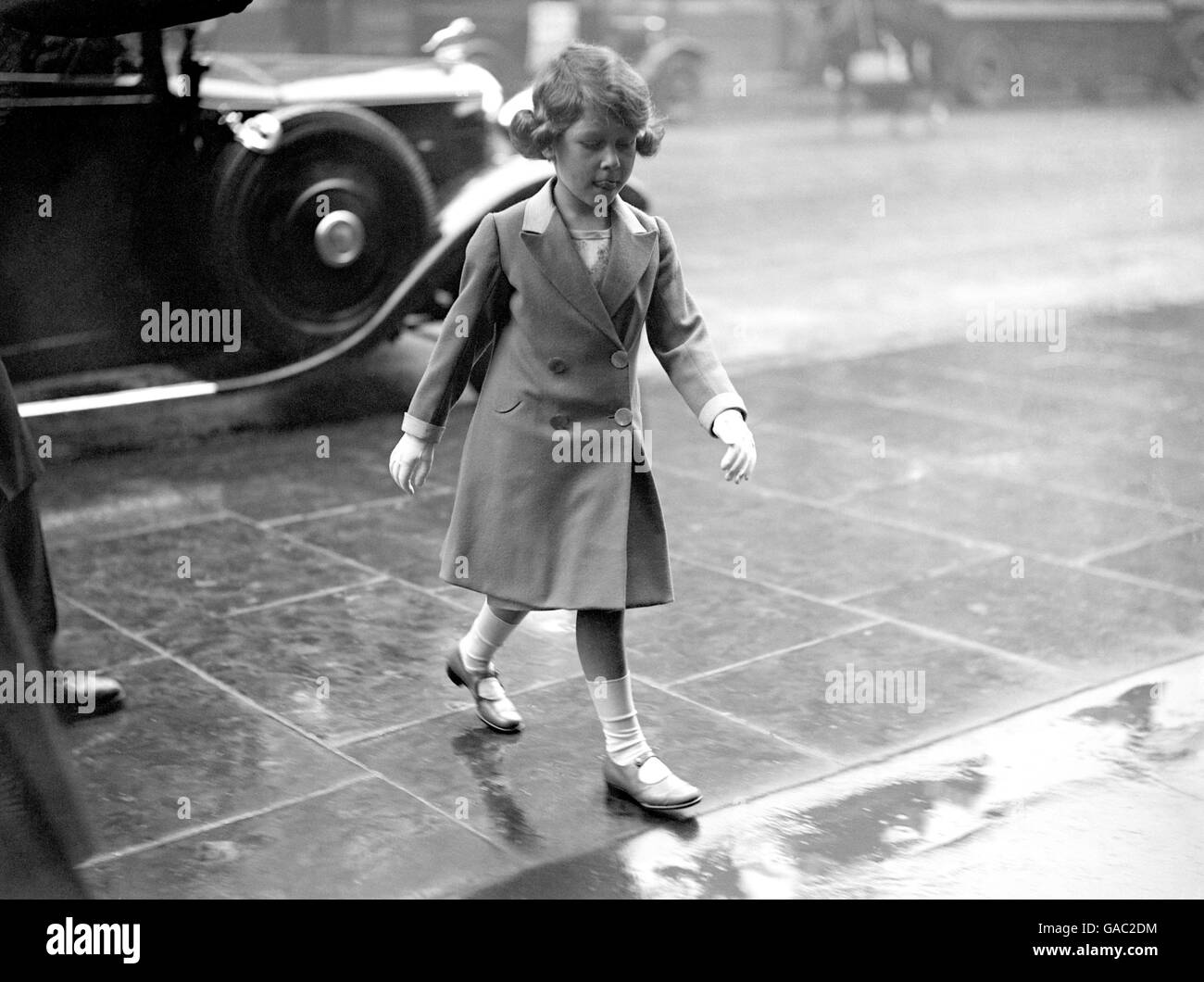 Princess Elizabeth walking bareheaded through the rain on her arrival home. Stock Photo
