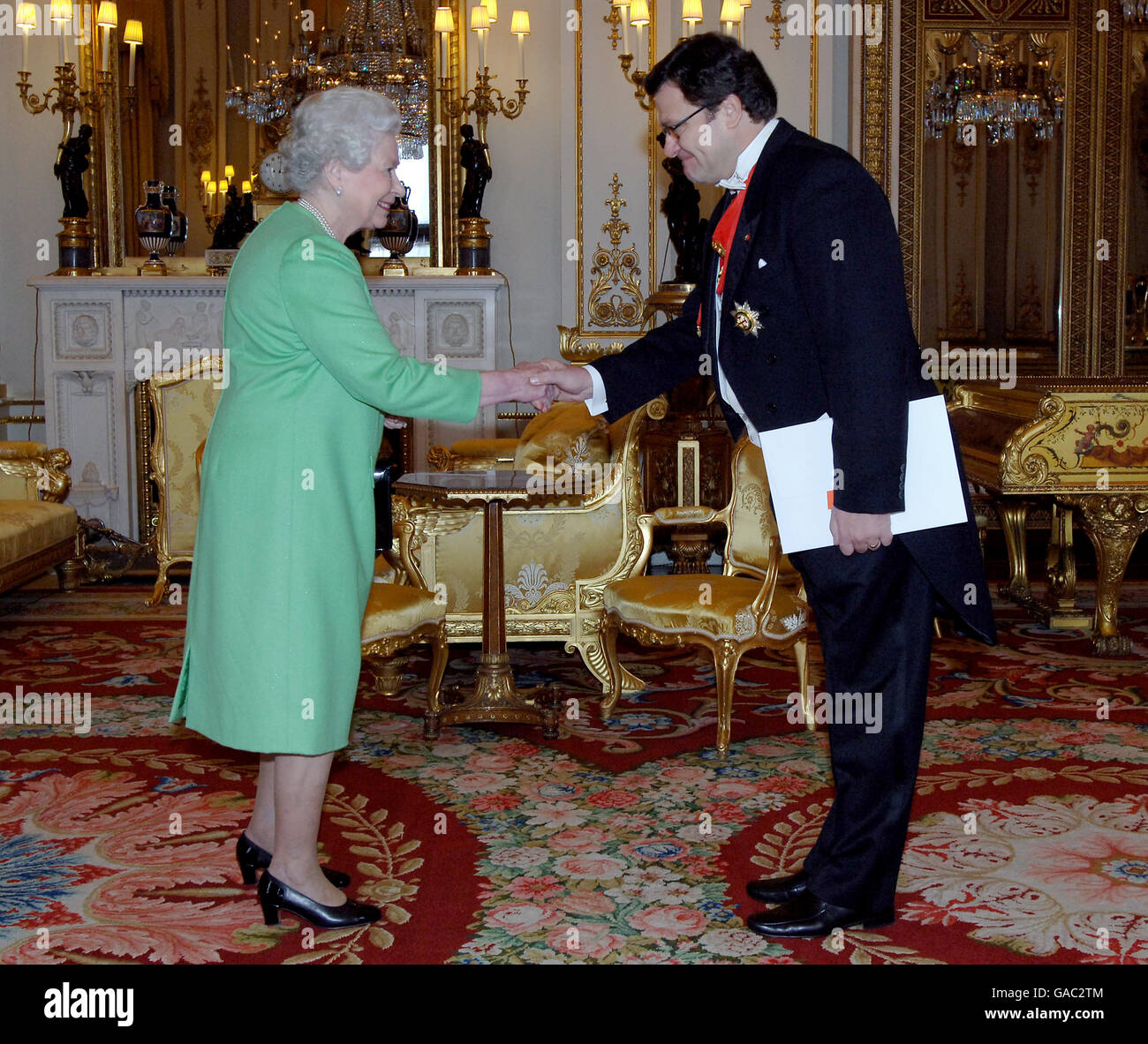 Britain's Queen Elizabeth II receives the Ambassador of Albania, Mr Zef Mazi, in the White Drawing Room at Buckingham Palace today. Stock Photo