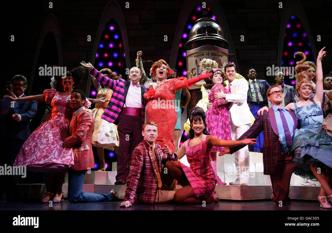 The cast of the musical 'Hairspray', including (centre left to rigth) Mel Smith (as Wilbur Turnblad), Michael Ball (Edna Turnblad), Leanne Jones (as Tracy Turnblad) and Ben James-Ellis (white suit, as Link Larkin) during a photocall at the Shaftesbury Theatre in central London. Stock Photo