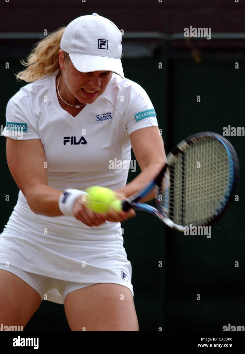 Tennis - Wimbledon 2002 - Second Round. Kim Clijsters makes a return back to Elena Likhovtseva Stock Photo