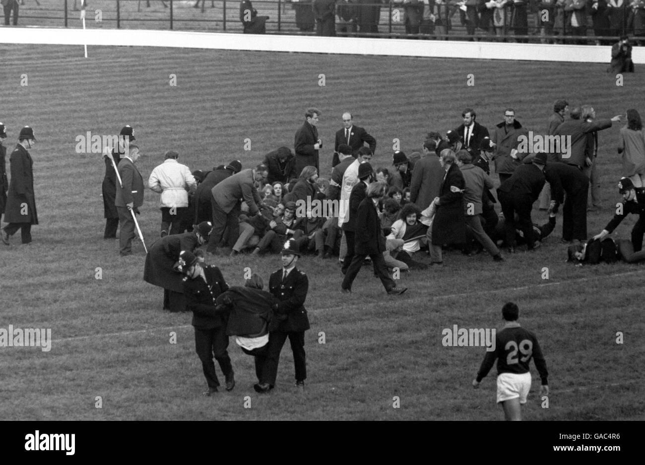 Anti-apartheid demonstrators stage a sit-down protest on the Twickenham pitch in order to halt play as policemen and RFU officials try to forcibly remove them Stock Photo