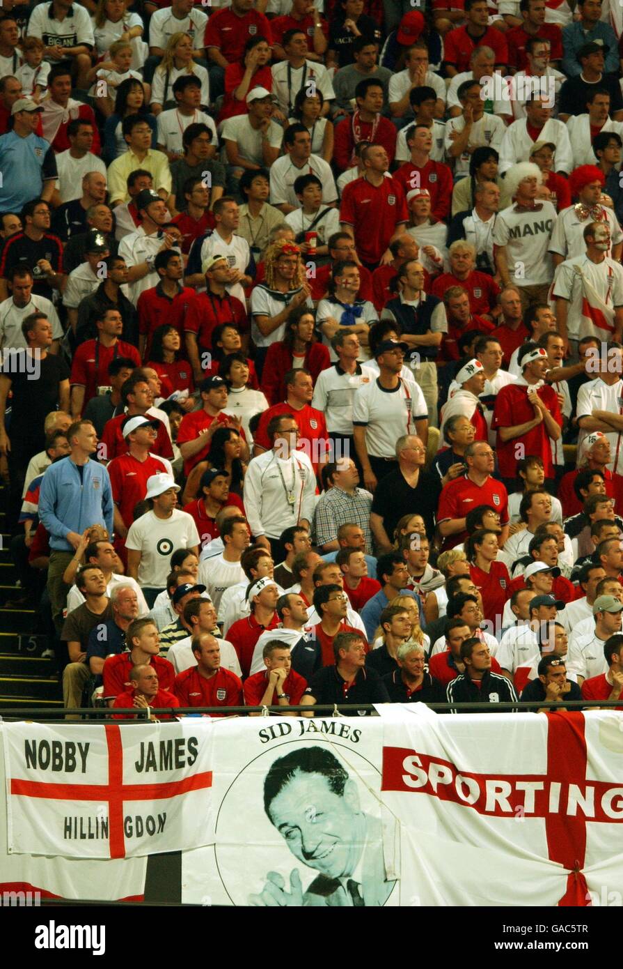 England fans watch the game with a banner of carry on actor Sid James Stock Photo