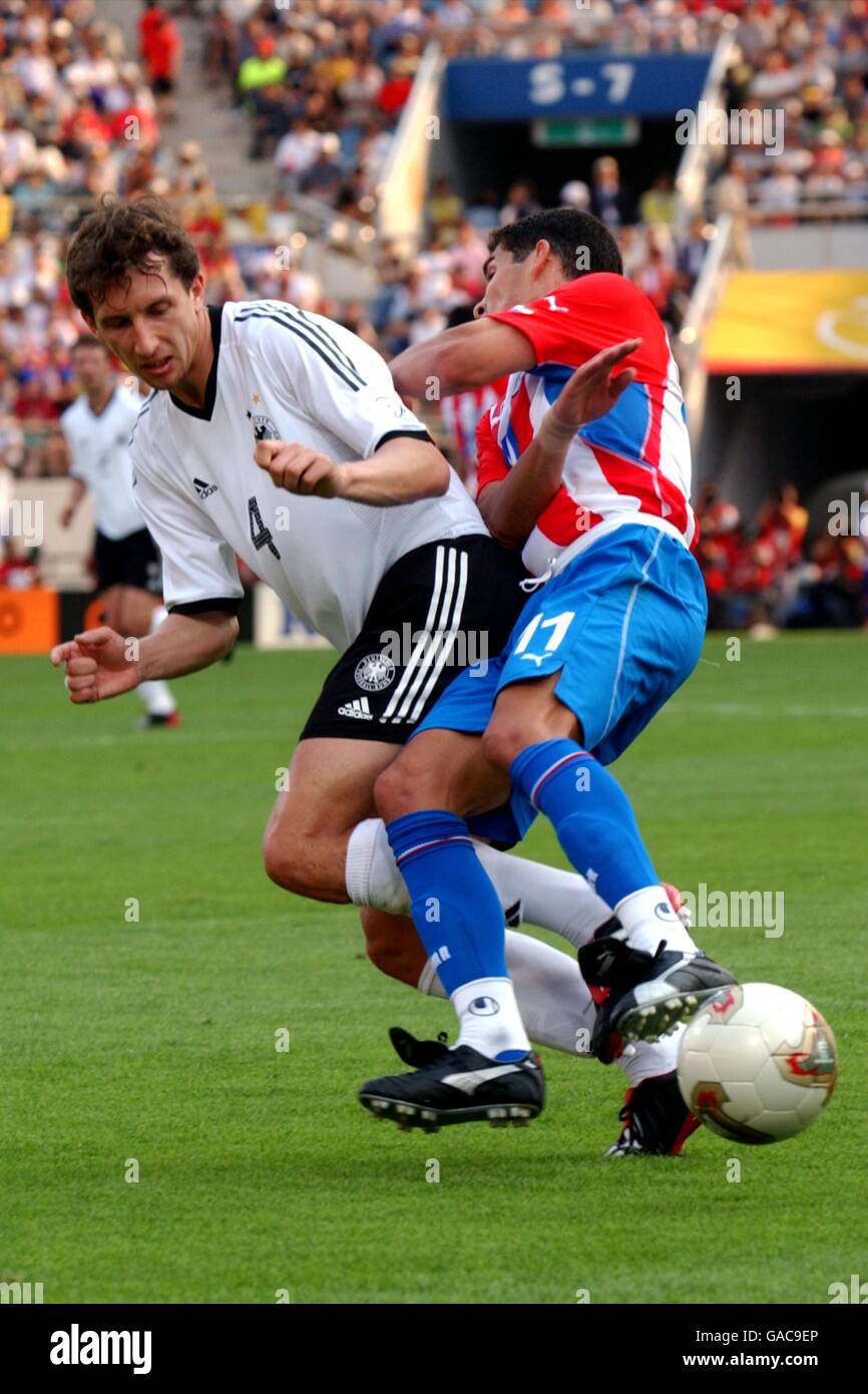Soccer - FIFA World Cup 2002 - Second Round - Gernany v Paraguay. Germany's Frank Baumann tackles Paraguay's Jorge Campos Stock Photo