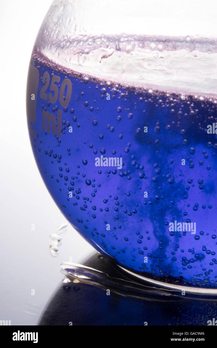 blue chemical reaction in boiling flask Stock Photo Alamy