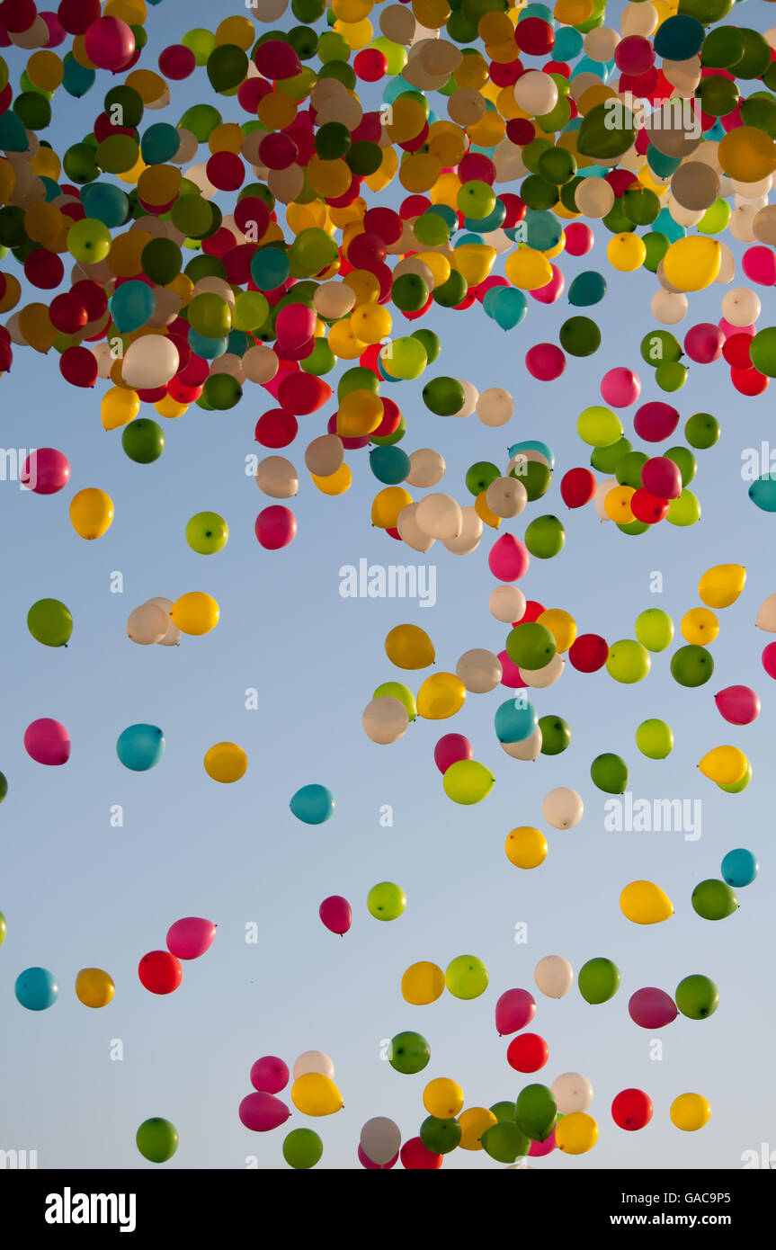 Balloon release during a celebration with a variety of colorful