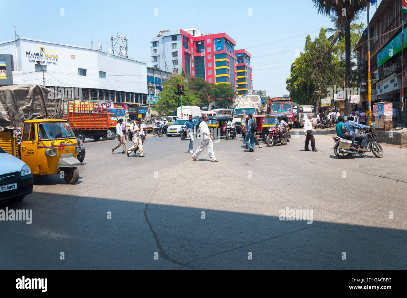 Street scene in Mumbai Maharashtra India crossing road by Mumbai Metro Hotel. Stock Photo