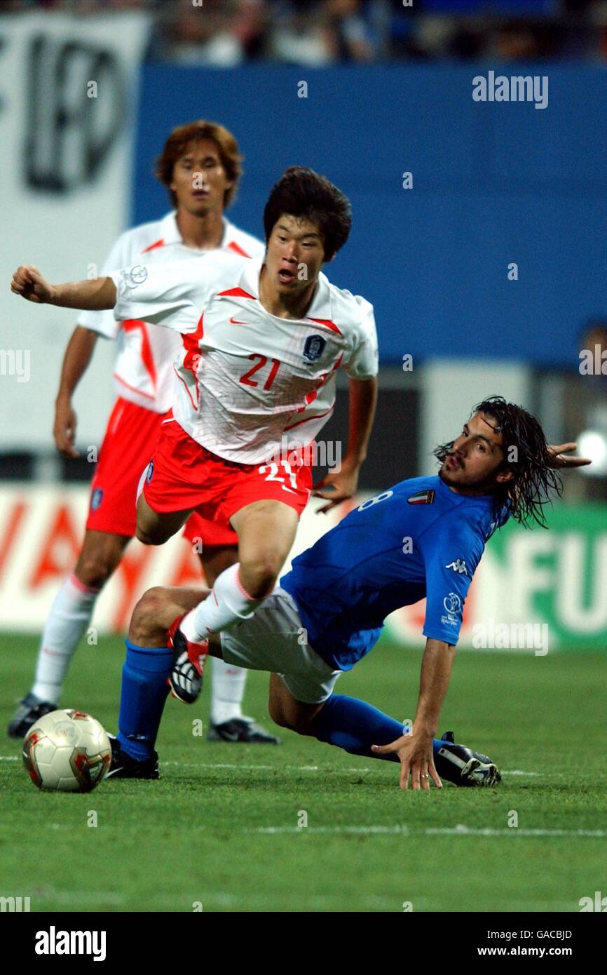 Korea's Ji Sung Park (l) jumps over a tackle from Italy's Gennaro Gattuso (r) Stock Photo