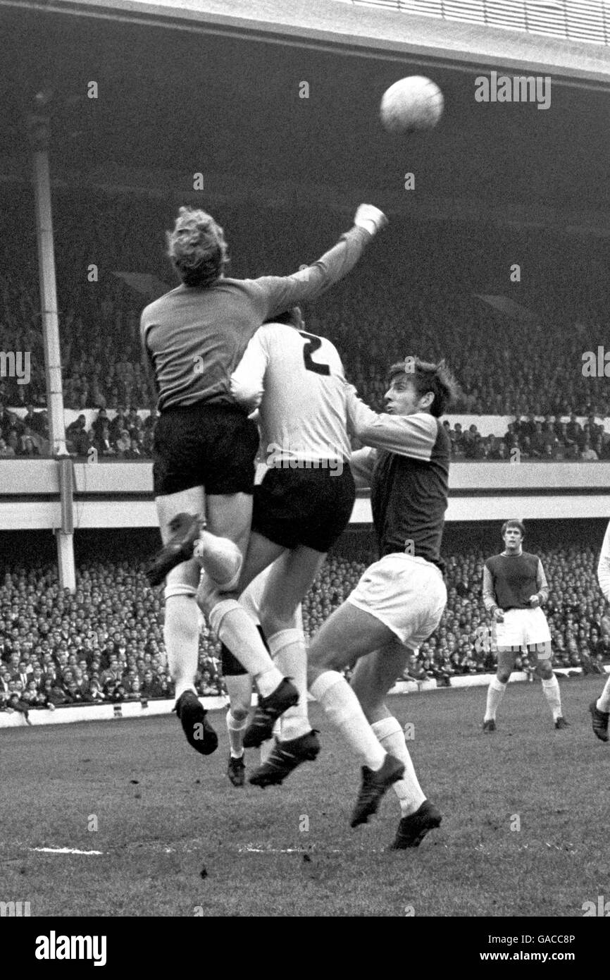 Soccer - League Division One - West Ham v Sunderland - Upton Park. Sunderland goalkeeper Jim Montgomery punches clear from Martin Peters of West Ham. No. 2 is Cecil Irwin of Sunderland. Stock Photo