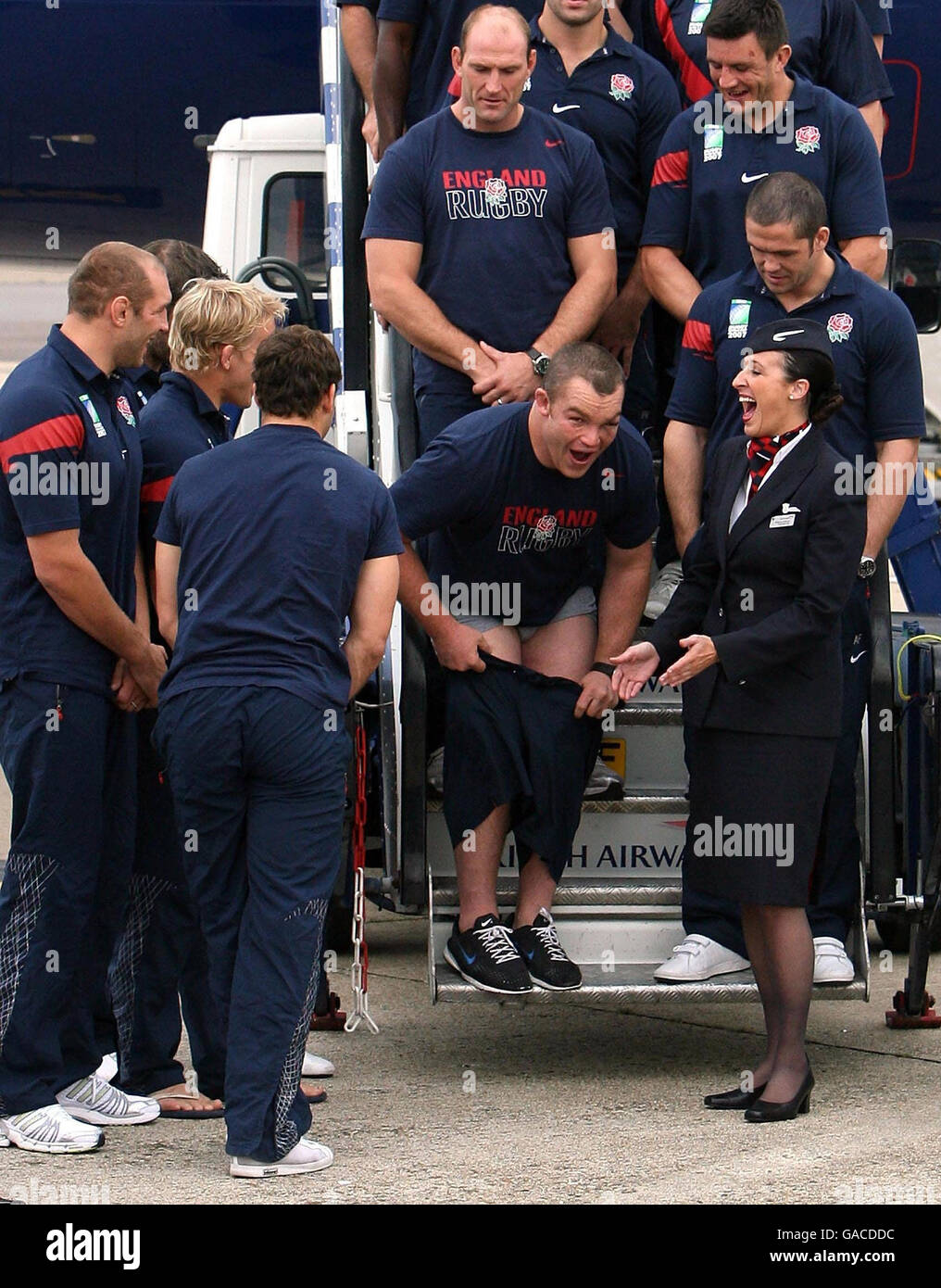 England's Matt Stevens holds his shorts after the rugby union team arrived at Heathrow Airport, London. Stock Photo