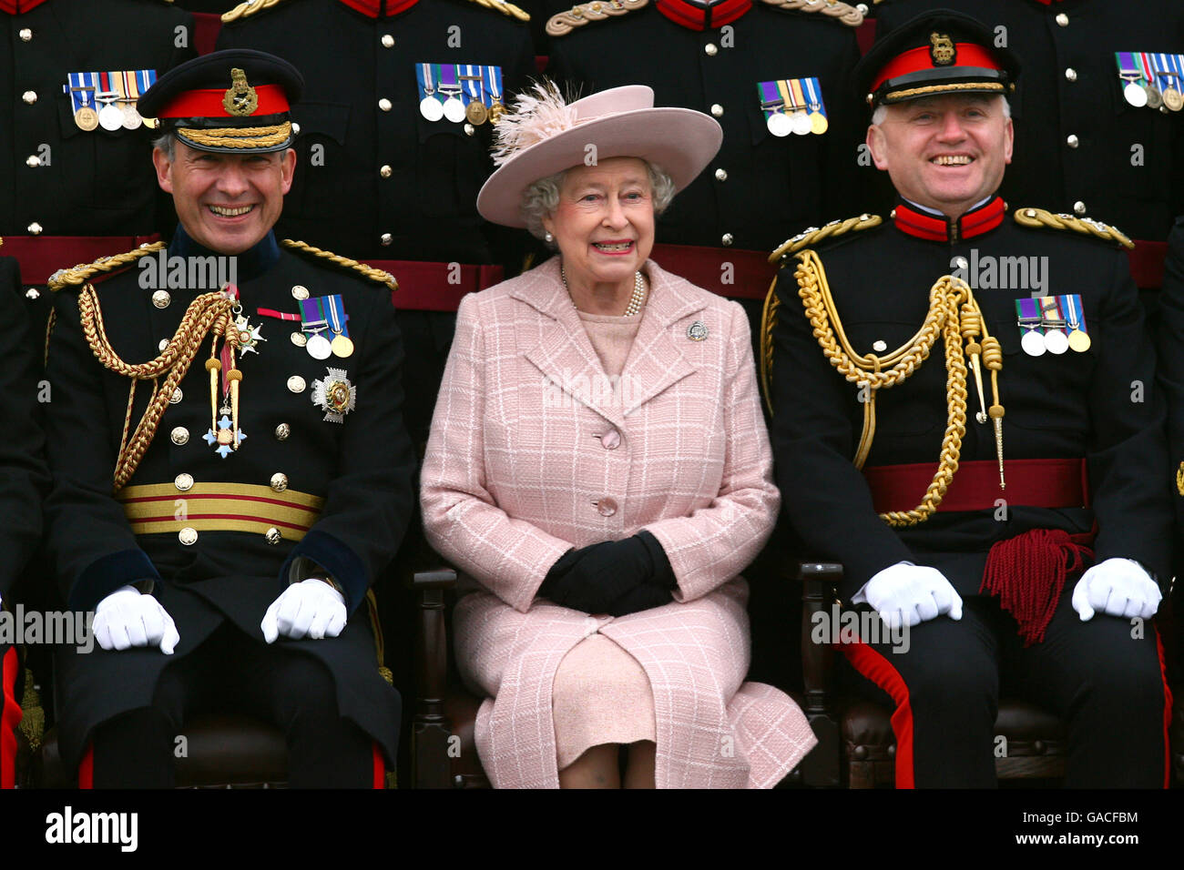 Great Britain's Queen Elizabeth II poses for a photograph, accompanied by Chief Royal Engineer Sir Kevin O'Donoghue (left) and Brigadier Chris Sexton during a visit to the Corps of Royal Engineers at Brompton Barracks, Chatham, Kent. Stock Photo