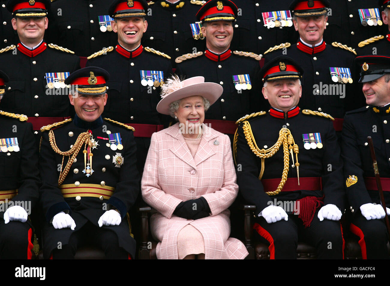 Britain's Queen Elizabeth II poses for a photograph, accompanied by Chief Royal Engineer Sir Kevin O'Donoghue (Left) and Brigadier Chris Sexton (Right) during a visit to the Corps of Royal Engineers at Brompton Barracks, Chatham, Kent. Stock Photo