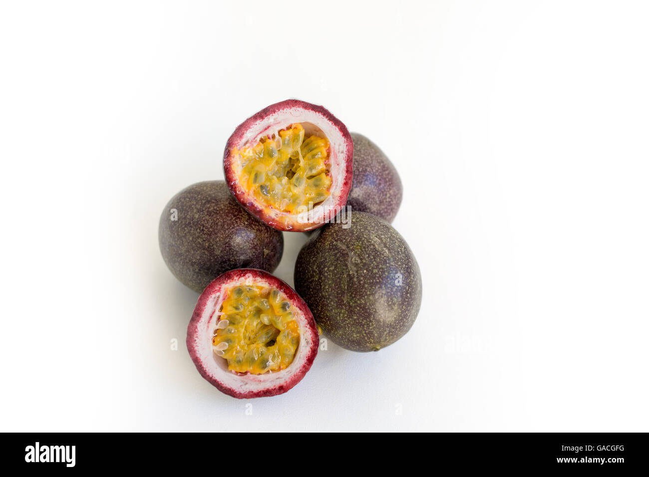 Sliced and whole passion fruit on a seamless white background Stock ...