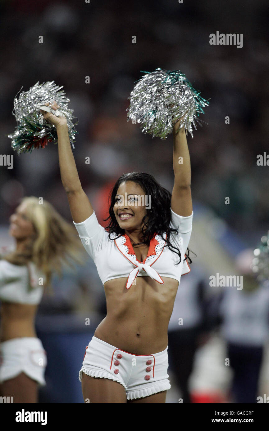 Cheerleaders perform prior to the NFC Eastern Division match between Miami Dolphins and New York Giants at Wembley, London. Stock Photo