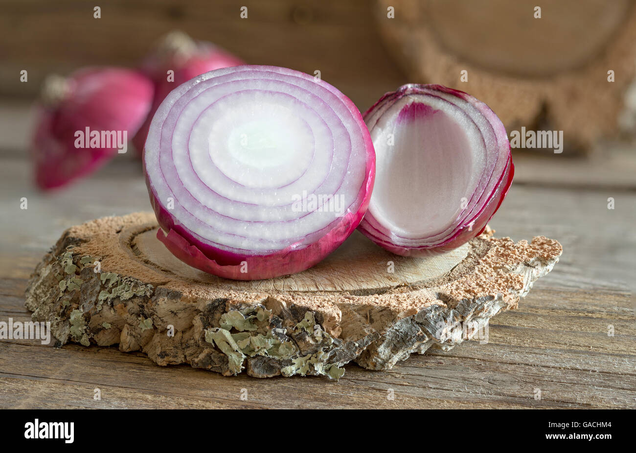 raw red onion on old wooden table Stock Photo - Alamy