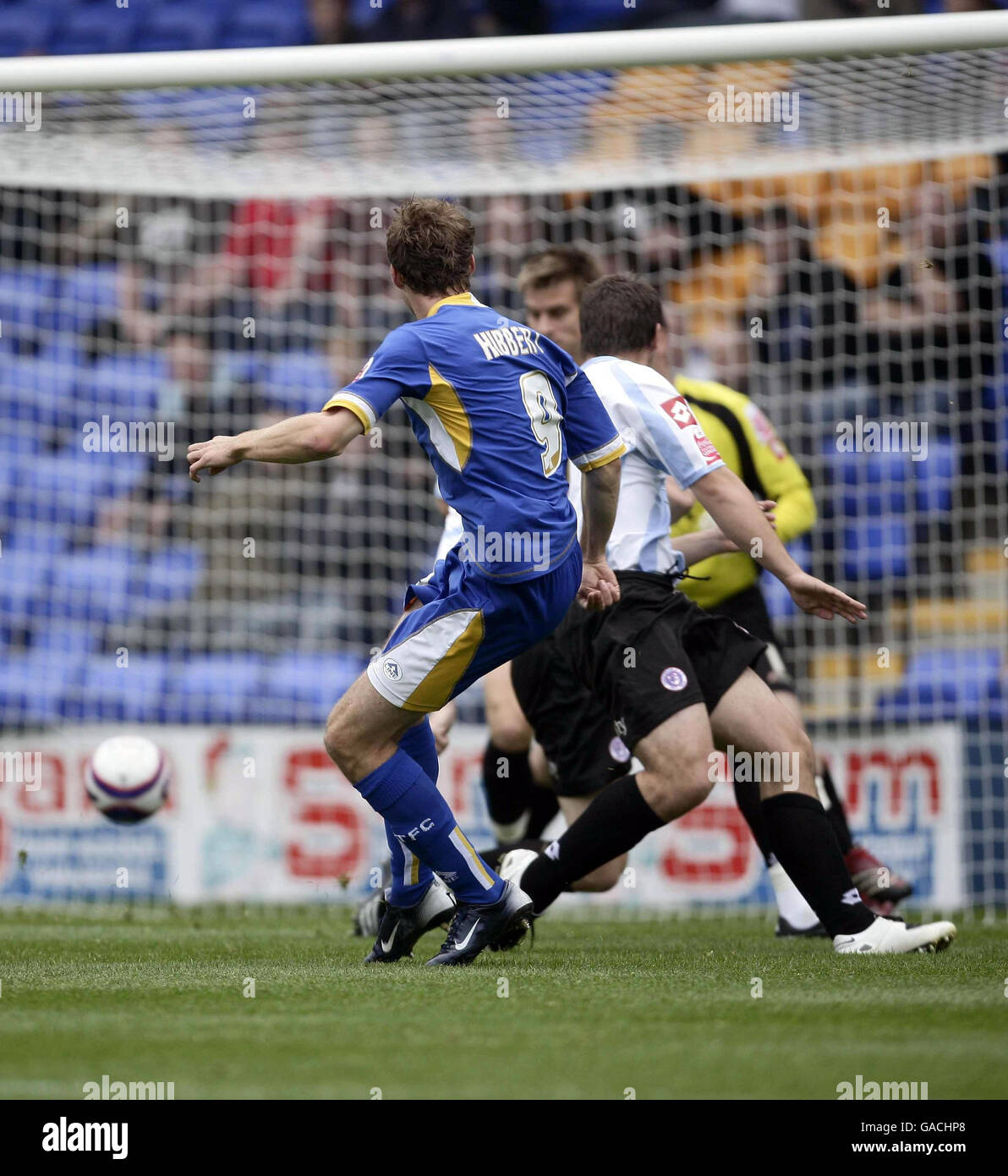 Shrewsbury's Dave Hibbert (left) watches as his shot goes in the net during the Coca-Cola League Two match at New Meadow, Shrewsbury. Stock Photo