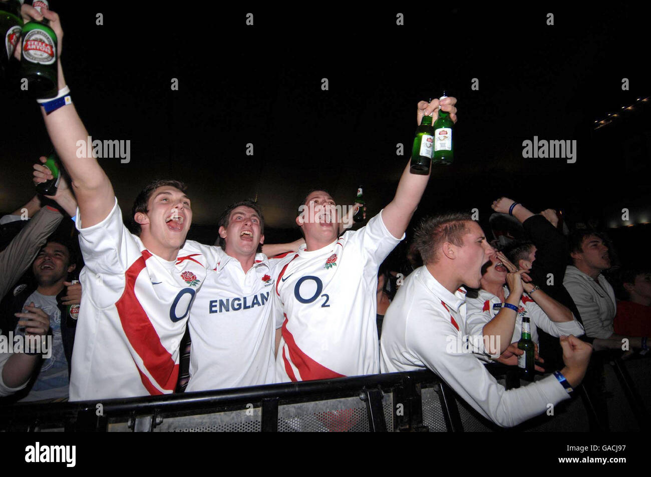 England fans celebrate after England score a try in the World Cup semi-final which is being shown on a giant screen in the O2 Arena in east London. Stock Photo