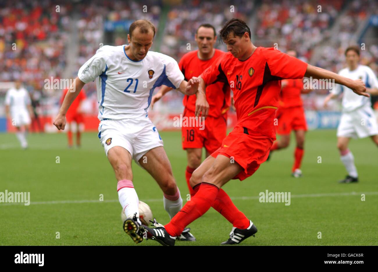 Soccer - FIFA World Cup 2002 - Group H - Belgium v Russia. Russia's Dmitry Khokhlov (l) and Belgium's Daniel Van Buyten battle for the ball Stock Photo