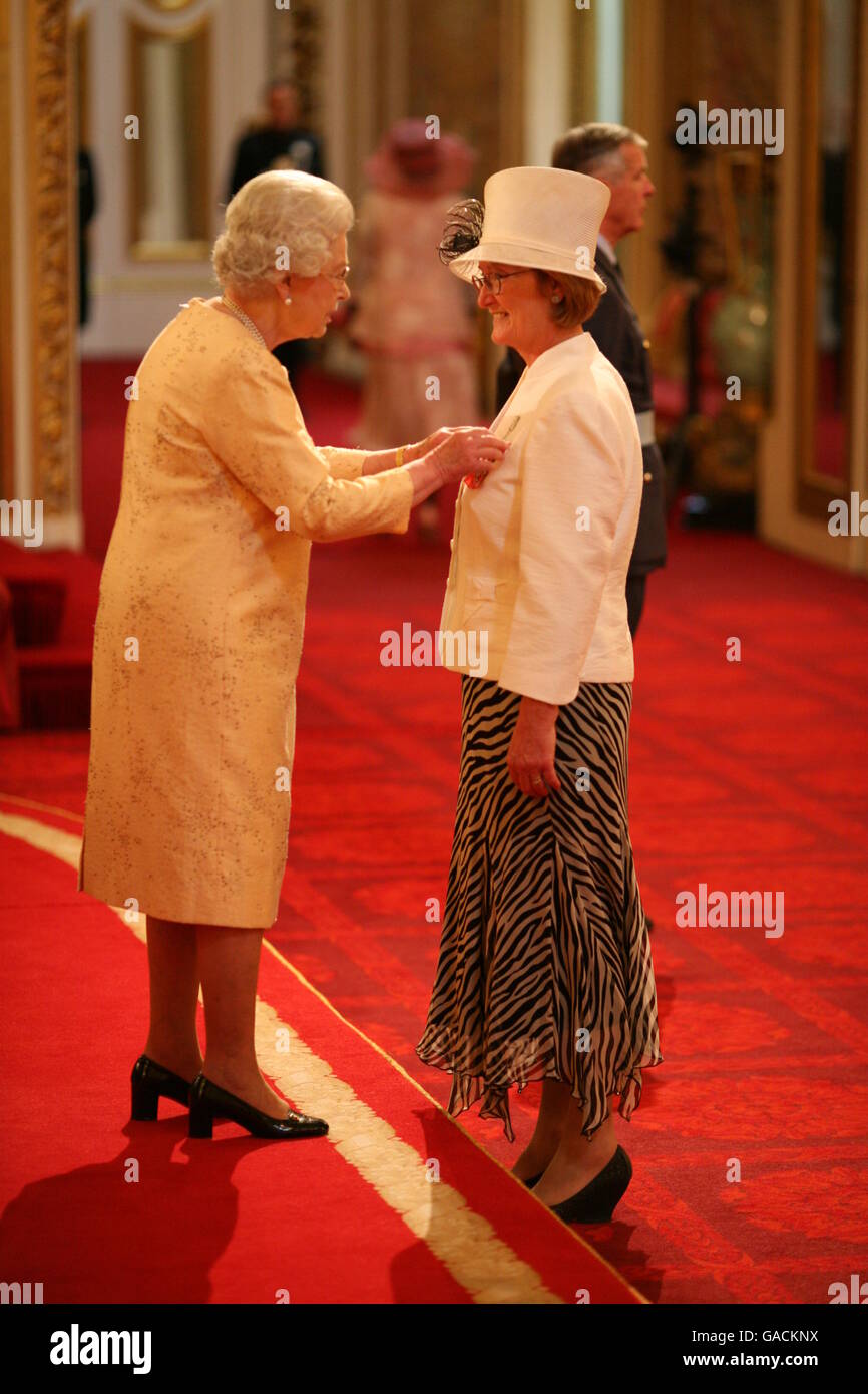 Mrs. Catherine Robertson, teacher, Bankhead Primary School, Glasgow, from Glasgow, receives an MBE from The Queen at Buckingham Palace, for services to Education. Stock Photo