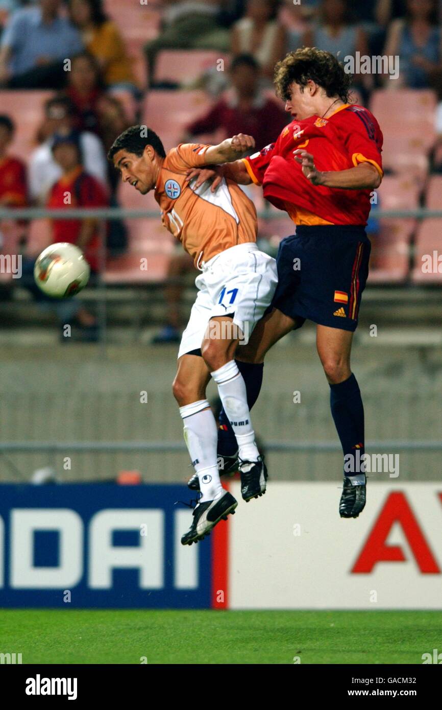 Soccer -FIFA World Cup 2002 - Group B - Spain v Paraguay. Spain's Carles Puyol (r) jumps for a header with Paraguay's Jorge Campos (l) Stock Photo