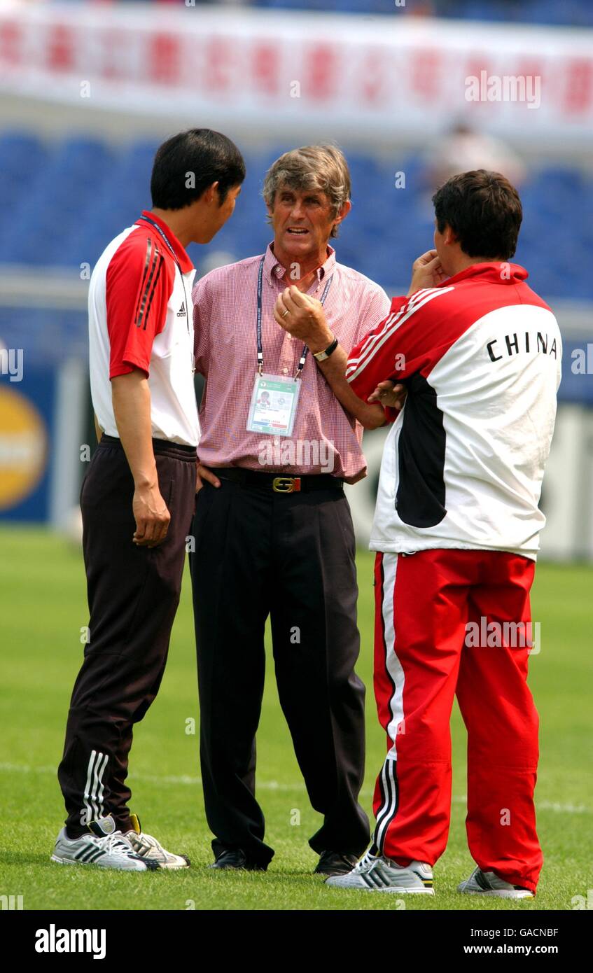 China Coach Bora Milutinovic (c) discusses tactics with his coaches Stock Photo