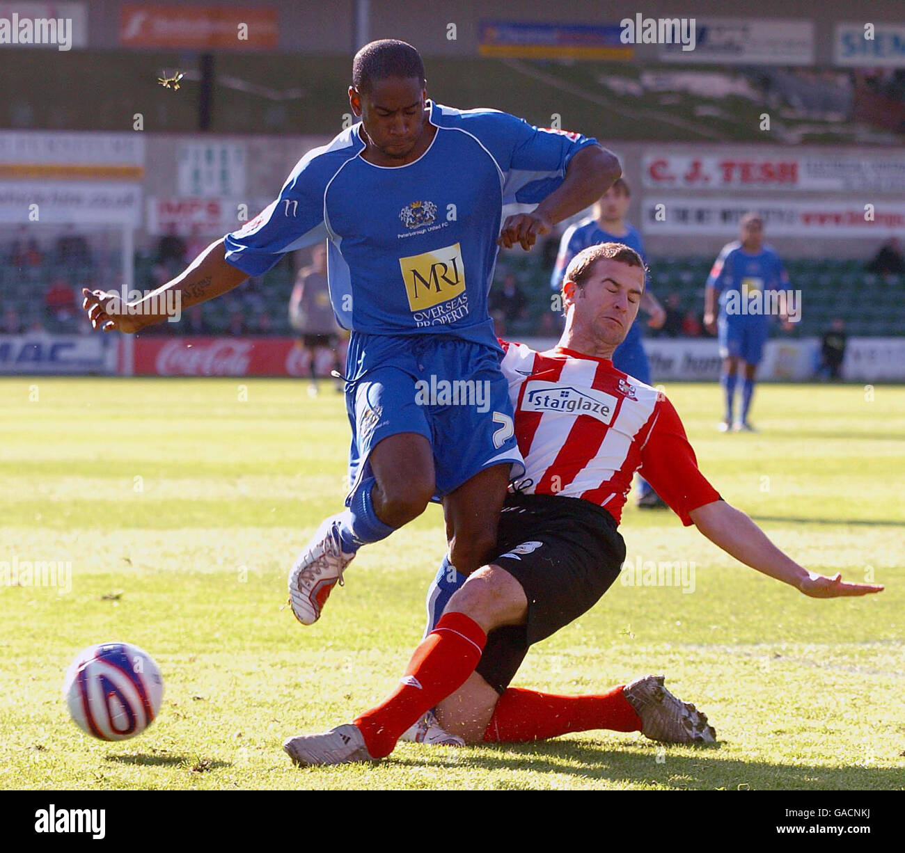 Lincoln's Gary Croft (right) challenges Peterborough's Adam Newton during the Coca-Cola Football League Two match at the Sincil Bank Stadium, Lincoln. PRESS ASSOCIATION photo Stock Photo