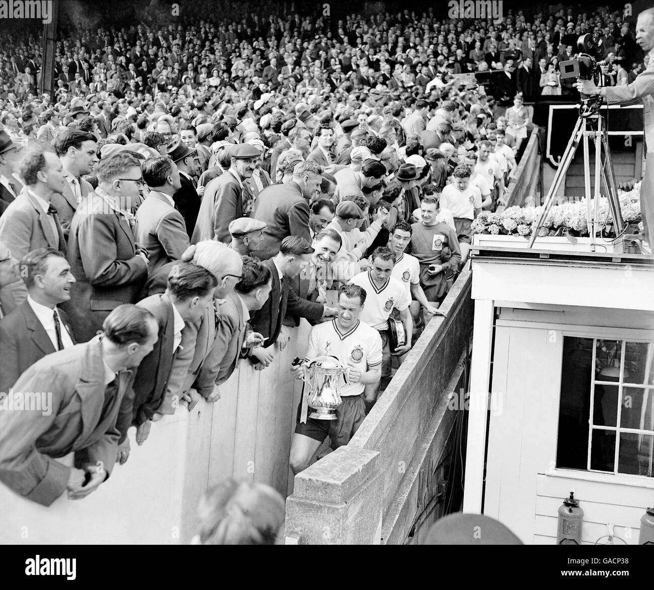 The winning captain, Bolton Wanderers' Nat Lofthouse, carries the FA Cup down the steps from the royal box after his brace of goals gave his side a 2-0 victory Stock Photo