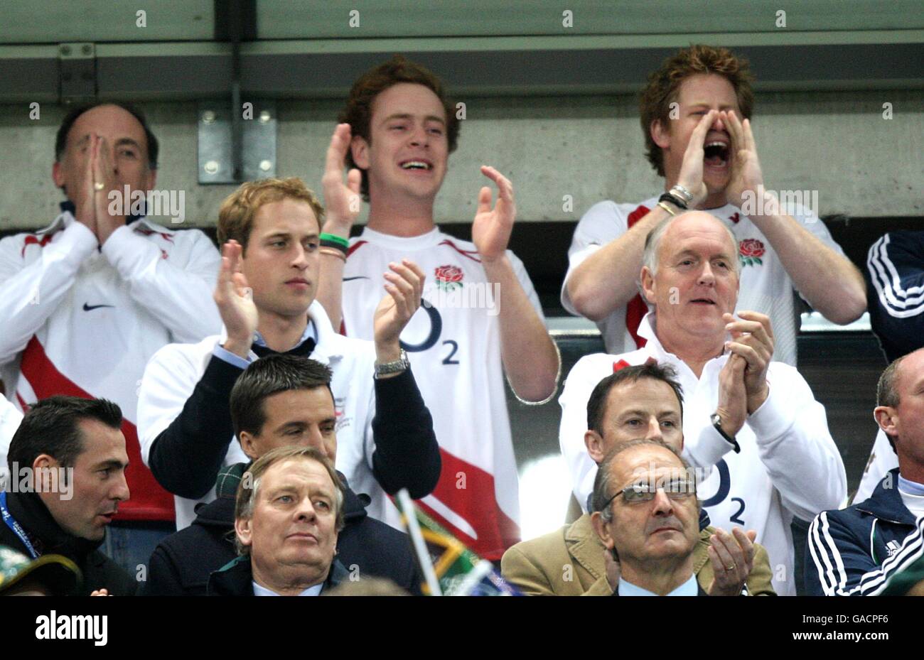 Prince William and Prince Harry cheer on the team from the stands Stock